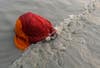 A Hindu pilgrim takes a dip at the confluence of the Ganges river and the Bay of Bengal at Sagar Island, India. Rupak De Chowdhuri is an India-based Reuters photographer. Check out more of his work <a href="http://www.americanphotomag.com/photo-gallery/2012/11/photojournalism-week-november-16-2012?page=3">here</a> and <a href="http://www.americanphotomag.com/photo-gallery/2012/11/photojournalism-week-november-9-2012?page=8">here</a>.