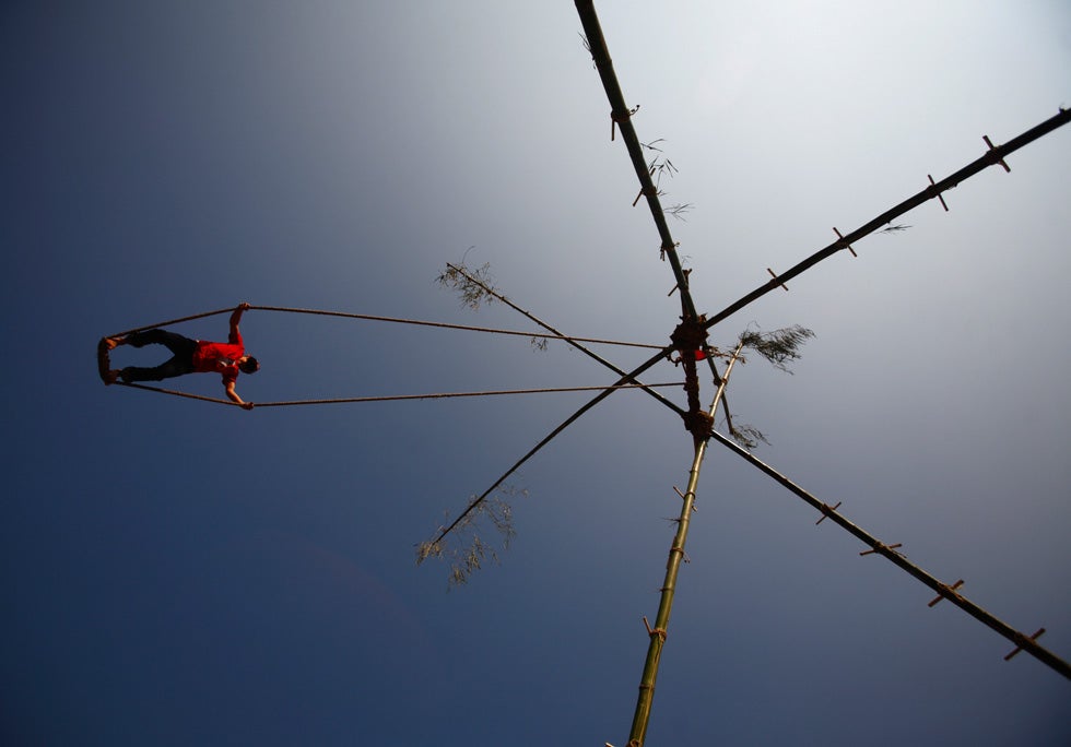 A Nepalese youth plays on a swing during the first day of Dashain, Hinduism's biggest religious festival, in Kathmandu, Nepal. Navesh Chitrakar is a Reuters staffer based in Nepal. His work has appeared in our weekly roundup more than any other photographer. See his image from the past two week's round-up <a href="http://www.americanphotomag.com/photo-gallery/2012/10/photojournalism-week-october-12-2012?page=9">here</a> and <a href="http://www.americanphotomag.com/photo-gallery/2012/10/photojournalism-week-october-5-2012?page=1">here</a>.