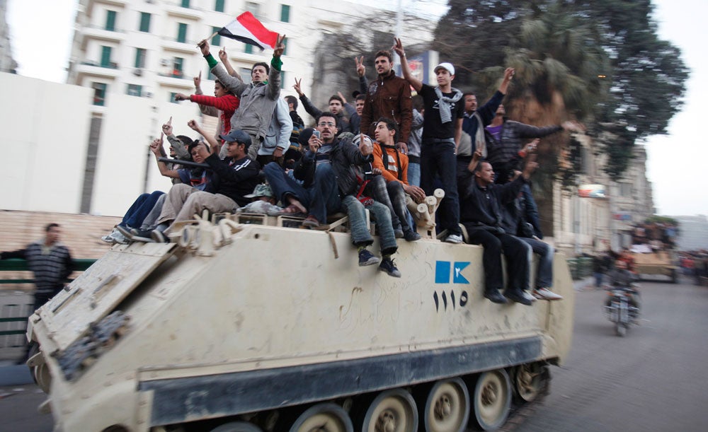 Protesters sit atop a military vehicle during demonstrations in Cairo January 29, 2011. Thousands of angry Egyptians rallied in central Cairo on Saturday to demand that President Hosni Mubarak resign, dismissing his offer of dialogue and calling on troops to come over to their side. Asmaa Waguih is a Reuters staffer currently based in Egypt. Like many of his other peers featured here, Asmaa is no stranger to violence. Take a look at his previous work documenting the frontlines of Syria <a href="http://www.reuters.com/news/pictures/slideshow?articleId=USRTR3EO44#a=1">here</a>, and see more from Egypt <a href="http://www.americanphotomag.com/photo-gallery/2013/04/photojournalism-week-april-26-2013?page=1">here</a>.