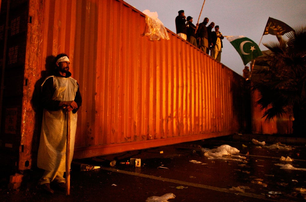 A supporter of Sufi cleric and leader of Minhaj-ul-Quran Muhammad Tahirul Qadri leans against a container blocking his and other protestors’ path as they head toward the Pakistani parliament building during the fourth day of demonstrations in Islamabad. Zohra Bensemra is a photojournalist working for Reuters in Pakistan.