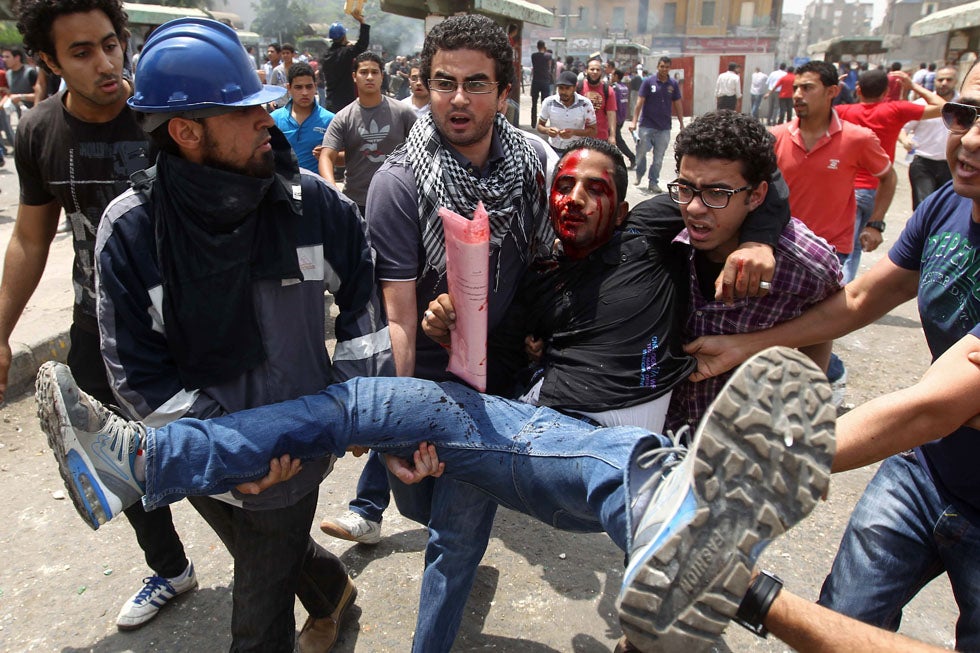 Egyptian anti-military protestors carry a wounded demonstrator away from violence in Cairo’s Tahir Square on May 2. More than 20 people were killed when unknown individuals attacked the anti-military sit-in. Khaled Desouki is an Egyptian resident and a staff photographer for AFP.