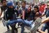 Egyptian anti-military protestors carry a wounded demonstrator away from violence in Cairo’s Tahir Square on May 2. More than 20 people were killed when unknown individuals attacked the anti-military sit-in. Khaled Desouki is an Egyptian resident and a staff photographer for AFP.