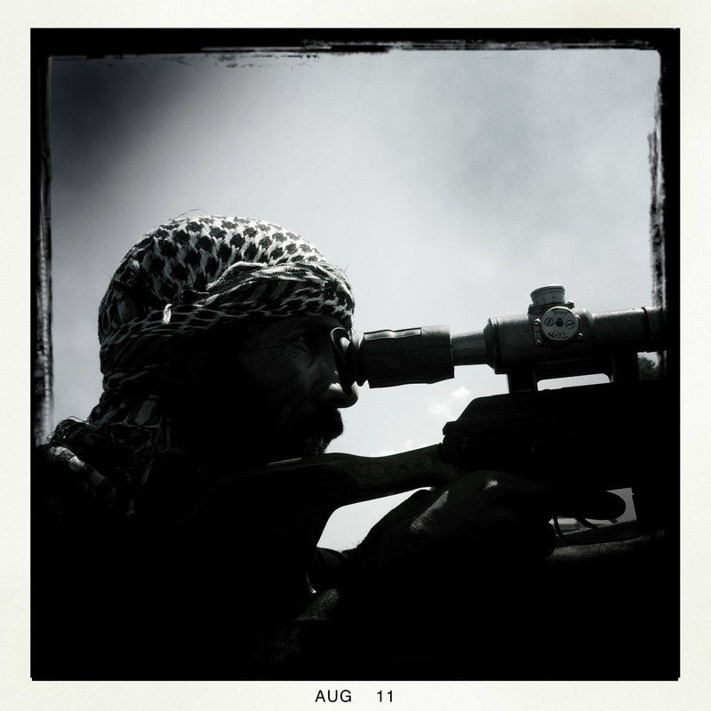 Rebel soldiers fight for control of a pro-Qaddafi neighborhood, Tripoli, Libya, Aug. 25, 2011. Several fighters on both sides were killed and wounded.