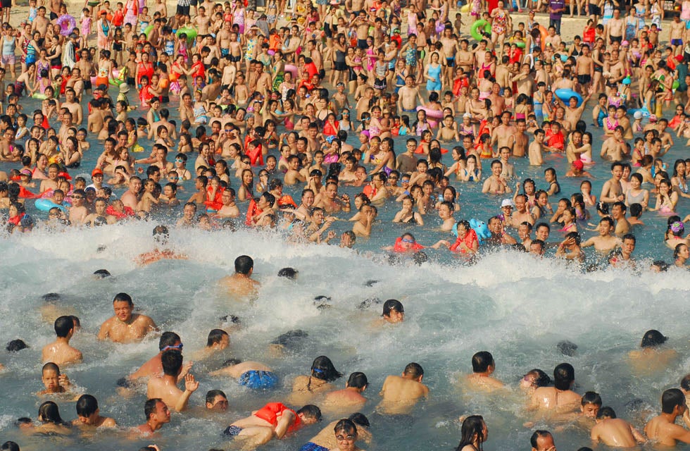 Visitors crowd in an artificial wave pool at a water park in Nanning, Guangxi Zhuang, China.