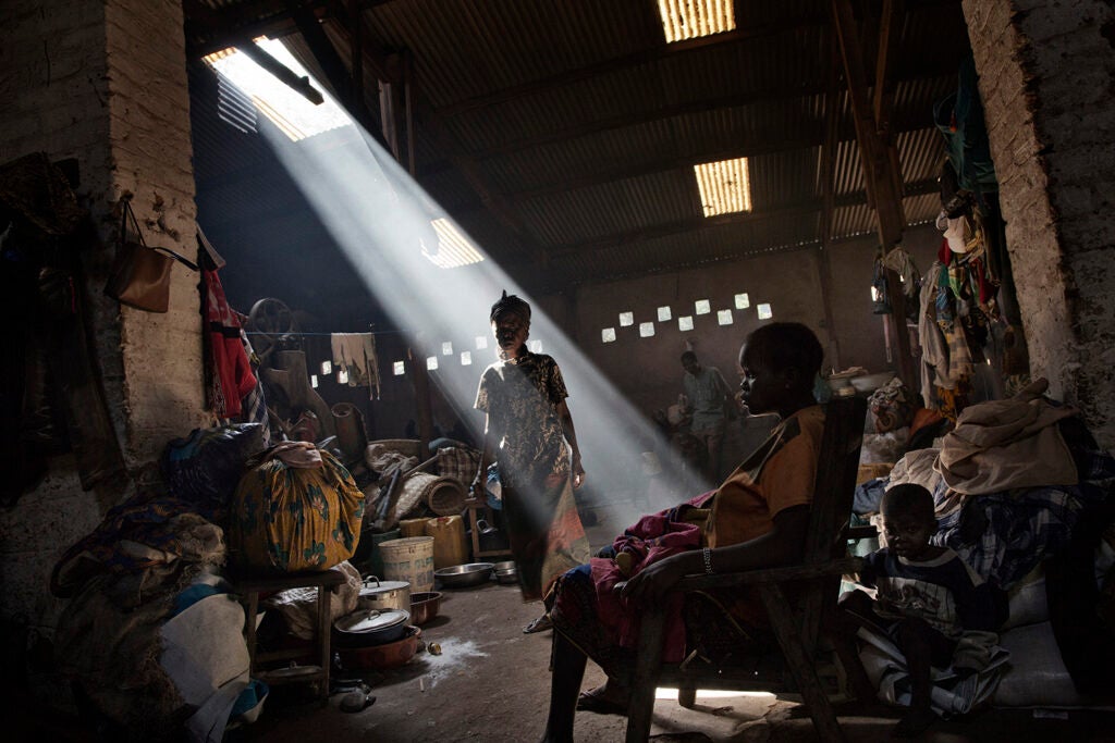 People displaced by the fighting between ex-Seleka and anti-balaka forces find shelter in an old factory on the grounds of the Catholic church in Bossangoa.  November 2, 2013.