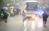 Glenn Chambers carries the Olympic Flame near Lincoln, England, during a heavy downpour, on Day 41 of the London 2012 Olympic Torch Relay. Chris Radburn is an Associated Press photographer also shooting for the London Organising Committee of the Olympic and Paralympic Games.