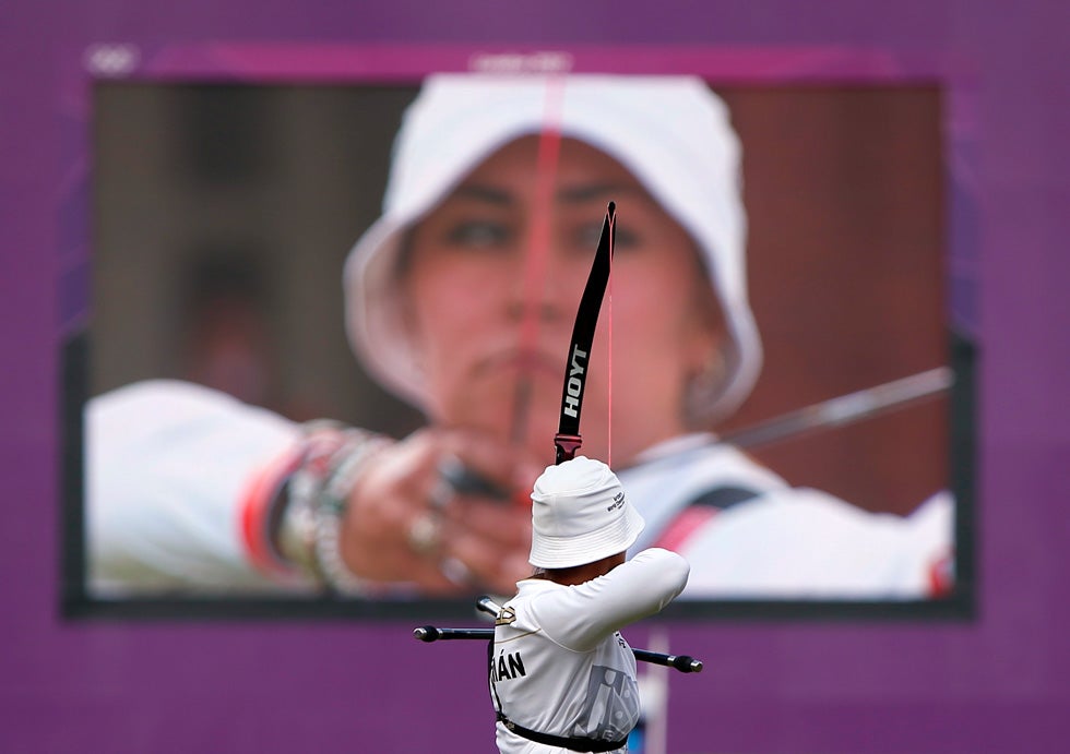 Mexico's Aida Roman competes as she is seen on a large screen during the women's individual archery final. Suhaib Salem is a Reuters photographer covering the 2012 Olympics. However, right up until the start of the Games, he was covering the presidential elections in Egypt.