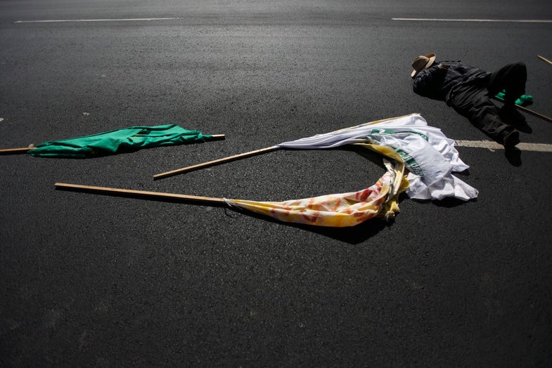 A peasant rests along a street next to his flags during a march, upon arrival in Mexico City January 9, 2013. The peasants who started this march 30 days ago in Villa Hermosa, in the state of Tabasco, are heading to the capital to seek government support to make their land more productive, according to local media. REUTERS/Edgard Garrido (MEXICO - Tags: CIVIL UNREST AGRICULTURE POLITICS)