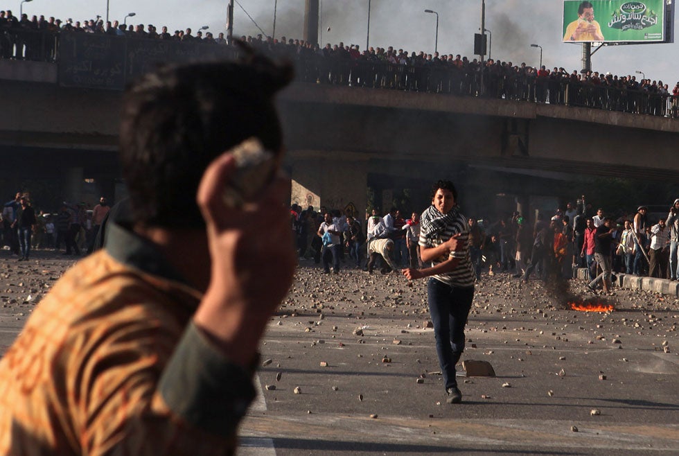 Protesters for and against President Mohamed Mursi clash in Cairo's Tahrir Square. Asmaa Waguih is a Reuters staffer currently based in Egypt. Take a look at his previous work, documenting the frontlines of Syria, <a href="http://www.reuters.com/news/pictures/slideshow?articleId=USRTR3EO44#a=1">here</a>.