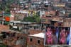 A billboard with pictures of a lingerie model is seen in front of the Commune northwest of Medellin city, Columbia. Albeiro Lopera is a photojournalist shooting for Reuters in Columbia.