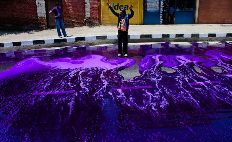 SRINAGAR, KASHMIR - MAY 09: A Kashmir government employee shouts anti government slogans after Indian police vehicle fired a jet of water towards them during a protest against government on May 09, 2012 in Srinagar, the summer capital of Indian Administered Kashmir, Indian. Hundreds of government employees staged an anti-Government demonstration to demand the fulfillment of long-pending demands including the regularisation of daily wages and the raising of retirement age from 58 to 60 years. Several protestors were injured and scores detained when Indian police used purple water cannons and batons to disperse the protestors. (Photo by Yawar Nazir/ Getty Images)