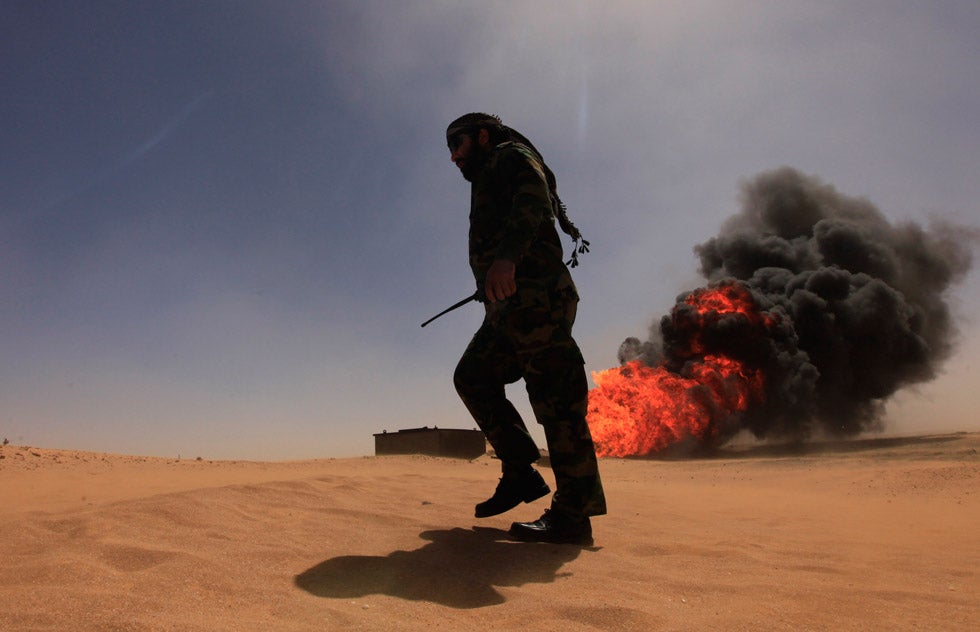 A security officer walks past a gas pipeline ablaze from a massive explosion 11 miles south of the city of Ajdabiyah, Libya. The cause of the explosion is still under investigation. Esam Al-Fetori is a fulltime freelance photographer in Libya currently shooting for Reuters. See more of his work <a href="http://www.americanphotomag.com/photo-gallery/2012/10/photojournalism-week-october-19-2012?page=4">here</a>.