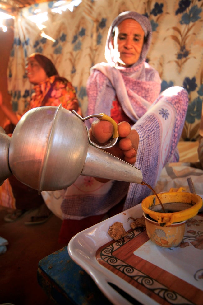 Reuters photographer Mohamed Nureldin Abdallah made this image of Hokom Al, a disabled women living in Khartoum, Sudan, pouring coffee for neighbors using her foot.