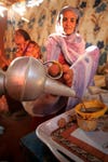 Reuters photographer Mohamed Nureldin Abdallah made this image of Hokom Al, a disabled women living in Khartoum, Sudan, pouring coffee for neighbors using her foot.
