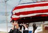 Members of the West Webster fire department load the casket of slain firefighter Michael Chiapperini onto a fire truck following his funeral service. Chiapperini and Tomasz Kaczowka were the two fire fighters killed several weeks ago in New York State by gunman, William Spengler, after he set his residence ablaze. Carlo Allegri is a Bermuda-born, Canadian photojournalist. A veteran of news coverage, his work has appeared in newspapers and magazines for 20 years. See more of his images on his <a href="http://www.lightstalkers.org/carloallegri">Lightstalkers page</a>.