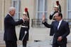 France's President Francois Hollande waves goodbye to U.S. Vice President Joe Biden after a working lunch and joint news conference at the Elysee Palace. Philippe Wojazer is a Reuters photographer based in Paris.