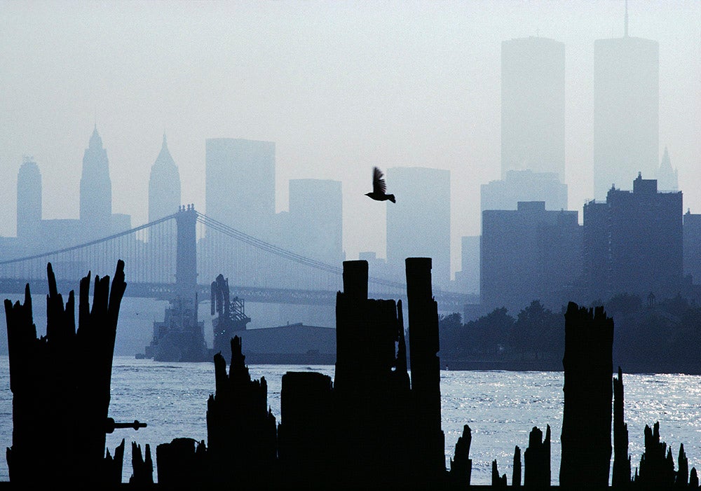 A view of the Downtown Manhattan skyline seen from Queens. Brooklyn Bridge and World Trade Center Towers. New York City, 1983.