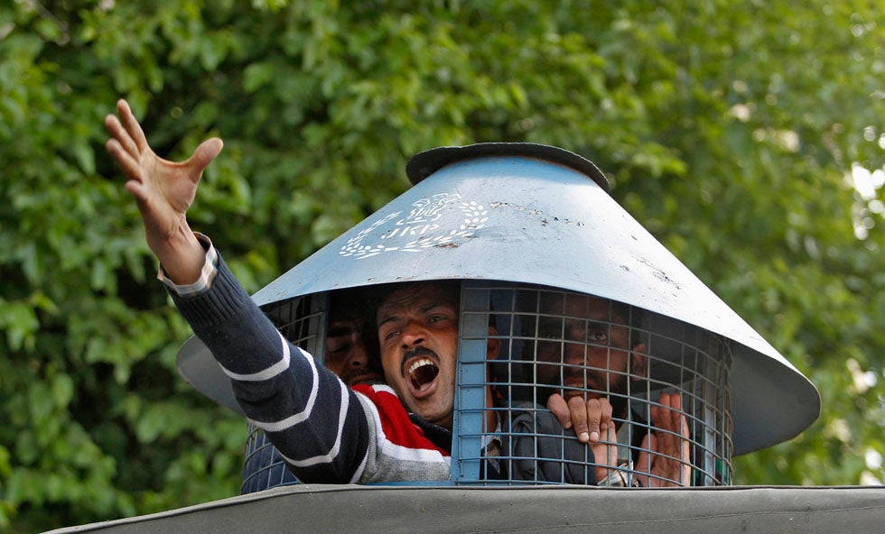 A government employee shouts slogans from inside a police vehicle after he was detained by police during a protest in Srinagar, India. Indian police detained dozens of employees on Wednesday during a protest demanding a greater regularization of temporary jobs and a hike in salary. Danish Ishmail is a photojournalist based in Srinagar, shooting for Reuters.