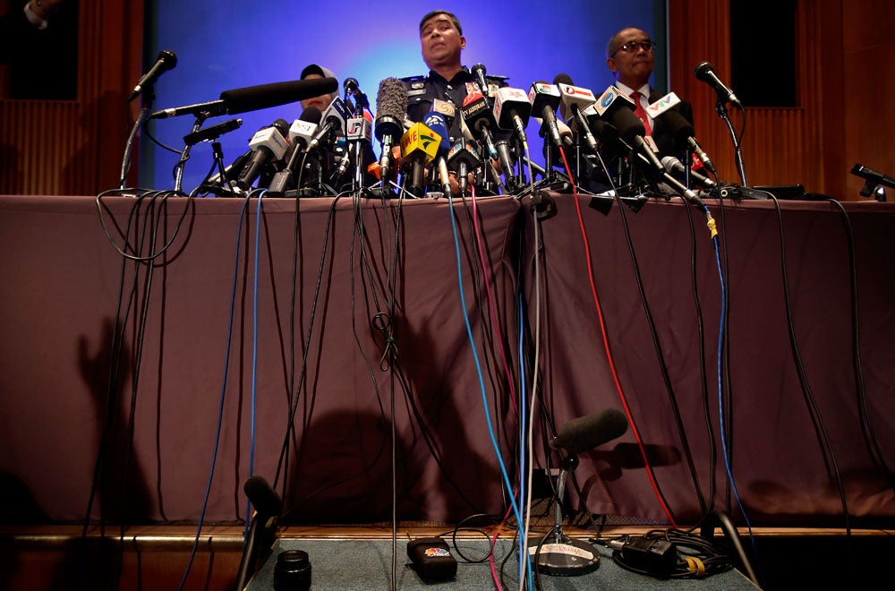 Over a dozen microphones are propped on a table as Malaysian police chief Khalid Abu Bakar answers questions about the missing Malaysia Airlines jetliner from members of the media during a press conference, Tuesday, March 11, 2014 in Sepang, Malaysia. Wong Maye-E is an AP staffer based in Singapore. Keep up to date with her work by following her on <a href="https://twitter.com/mayersINsg">Twitter</a>.