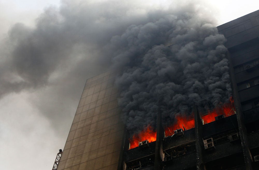 The building of the ruling National Democratic party burns after it was set ablaze by protesters. Egyptian President Hosni Mubarak refused on Saturday to bow to demands that he resign after ordering troops and tanks into cities in an attempt to quell an explosion of street protests against his 30-year rule. Yannis Behrakis is a Reuters staffer who is no stranger to protests. Check out some of his other work covering the upheaval in Turkey earlier this summer <a href="http://www.americanphotomag.com/photo-gallery/2013/06/turkish-protests-photos-so-far?page=7">here</a>.