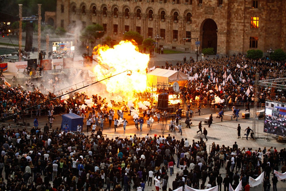 Faulty gas-filled balloons cause an explosion at a campaign rally in Yerevan, Armenia, injuring at least 144 individuals. Tigran Mehrabyan is a photographer for the PanARMENIAN news agency, the nation’s first web-based news organization.