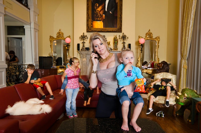Former beauty queen and wife of billionaire David Siegel, Jackie, 43, is surrounded by her children in the living room of their Orlando, Florida mansion. She and her husband, the owner of the largest timeshare business in the world, were in progress toward building the biggest house in America, a 90,000 square foot home inspired by the Palace of Versailles, when the financial crisis hit.