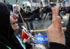 A female protestor clashes with police officers outside the Syrian consulate in Istanbul, Turkey. Demonstrators in many European countries, including Turkey and Great Britain, have taken to the streets to voice their disapproval of Syrian President Bashar al-Assad, who is violently squashing opposition protesters in his own country. Getty Images stringer <a href="http://www.lightstalkers.org/bulent_kilic">Bulent Kilic</a>, who made this image, was born and raised in Turkey. He graduated the Aegean Journalism Facility in 2003, and has been working as a stringer for AFP and various other Turkish publications for the past nine years. He currently lives and work in Istanbul.