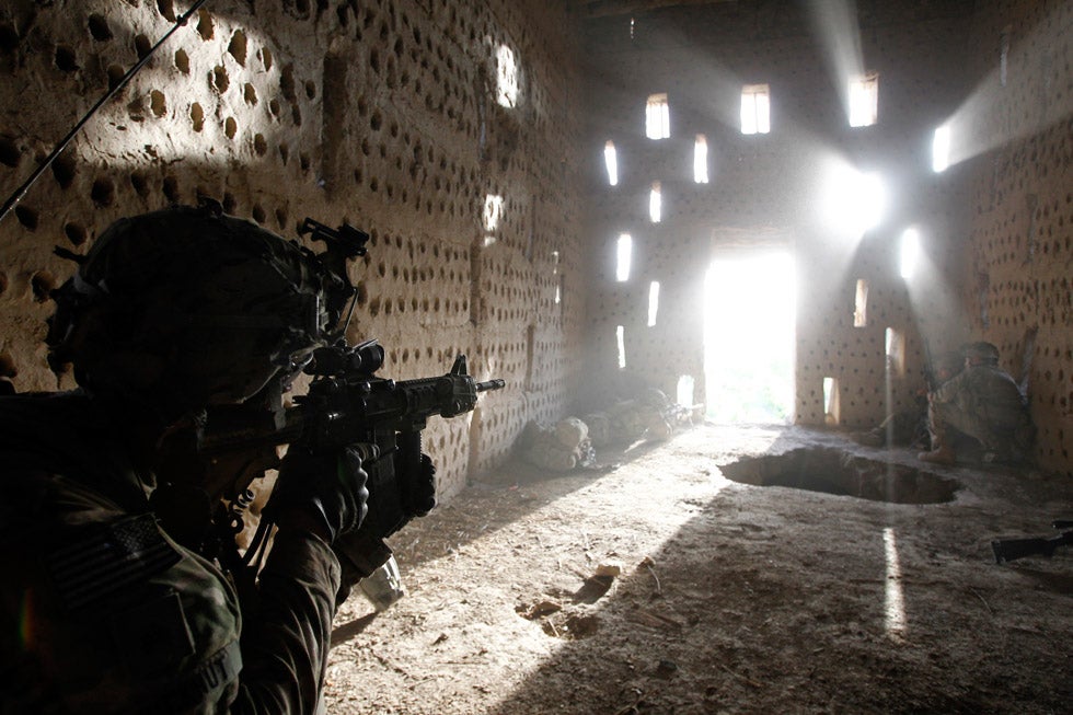 U.S. soldier Nicholas Dickhut points his rifle through a doorway in the Kandahar province of Afghanistan, as his regiment comes under Taliban fire. Baz Ratner is a veteran conflict photographer and staffer for Reuters. He was a Pulitzer Prize finalist in 2006 for his work covering the military conflict in Lebanon. You can see more of his work on his <a href="http://www.bazratner.com/">personal site</a>.