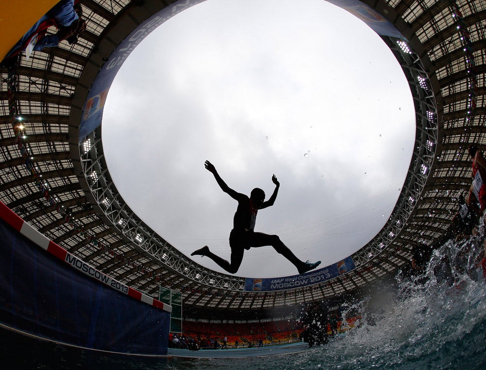 Paul Kipsiele Koech of Kenya jumps a water obstacle in the men's 3000 metres steeplechase heat during the IAAF World Athletics Championships at the Luzhniki Stadium in Moscow August 12, 2013.    REUTERS/Kai Pfaffenbach (RUSSIA  - Tags: SPORT ATHLETICS)   - RTX12I3J