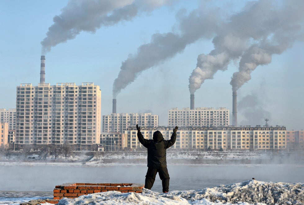 An elderly man exercises in the morning on the banks of the Songhua River in Jilin, Jilin province, China.