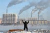 An elderly man exercises in the morning on the banks of the Songhua River in Jilin, Jilin province, China.