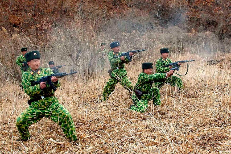 North Korean soldiers with weapons attend military training in an undisclosed location in this picture released by the North's official KCNA news agency.