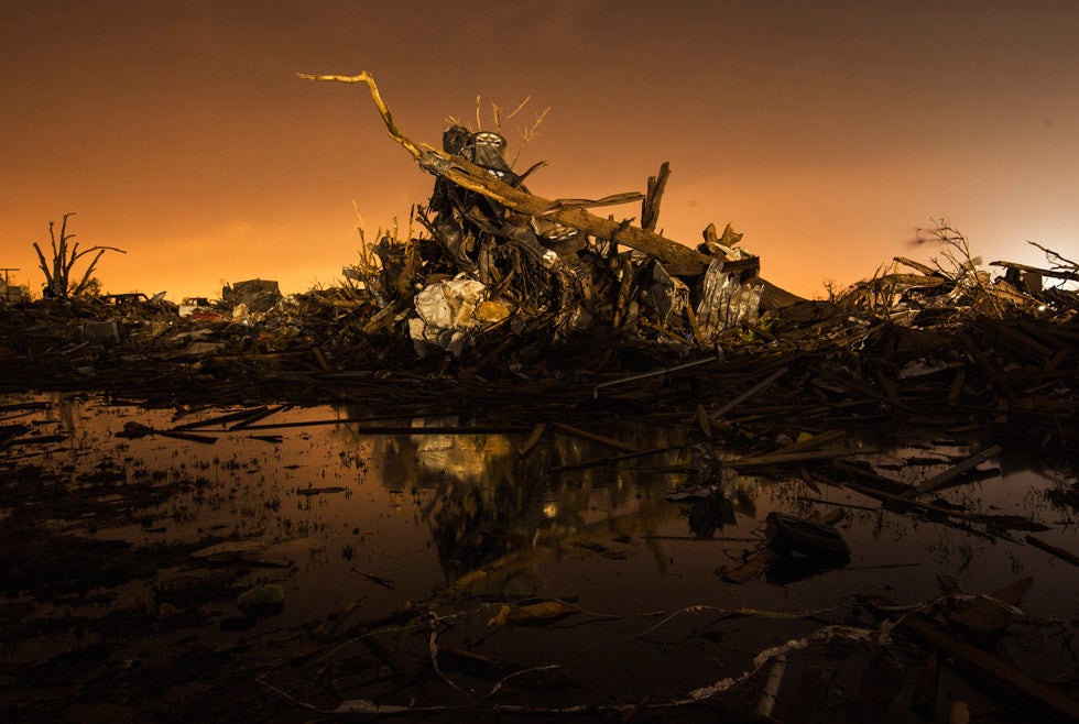 A car rests on top of a pile of debris pushed up by the wind in an area heavily damaged by the May 20 tornado in Moore, Oklahoma. Read the story behind this image in our <a href="http://www.americanphotomag.com/photo-gallery/2013/05/lucas-jacksons-long-exposures-oklahoma-aftermath">exclusive interview with Lucas Jackson.</a>