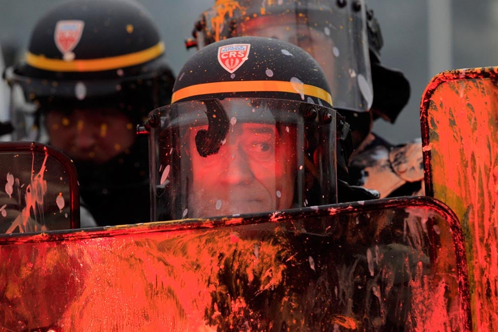 French CRS riot police are covered with paint during clashes with demonstrators in front of the Goodyear Dunlop French headquarters in Rueil Malmaison. The tire-maker is planning on closing a major plant in northern France, which would put a total of 1,173 people out of work. Gonzalo Fuentes is a freelance photographer shooting for Reuters. See more of his work <a href="http://www.gonzalofuentes.com/">here.</a>