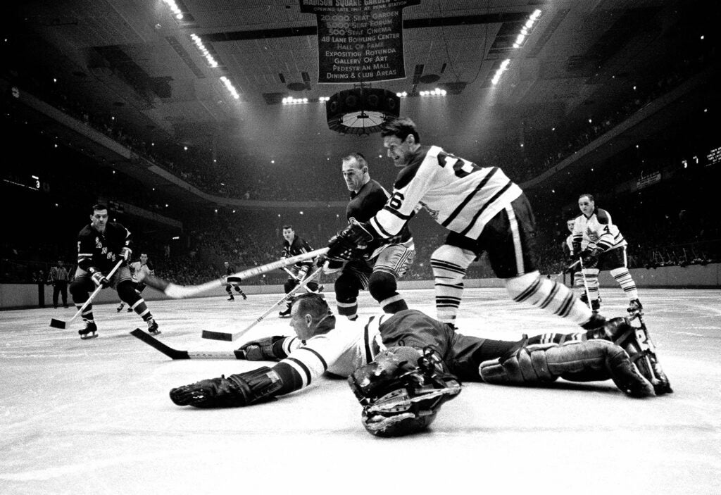 Bernie Geoffrion of the N.Y. Rangers shooting the puck pasted Johnny Bower of the Toronto Maple Leafs during a Hockey Game played in the Old Madison Square Garden, 1966.
