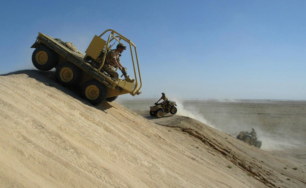 Soldiers from the 1st Battalion The Parachute Regiment practice driving all terrain vehicles in the Kuwaiti desert. From: <em>War is Beautiful</em> by David Shields, published by powerHouse Books.