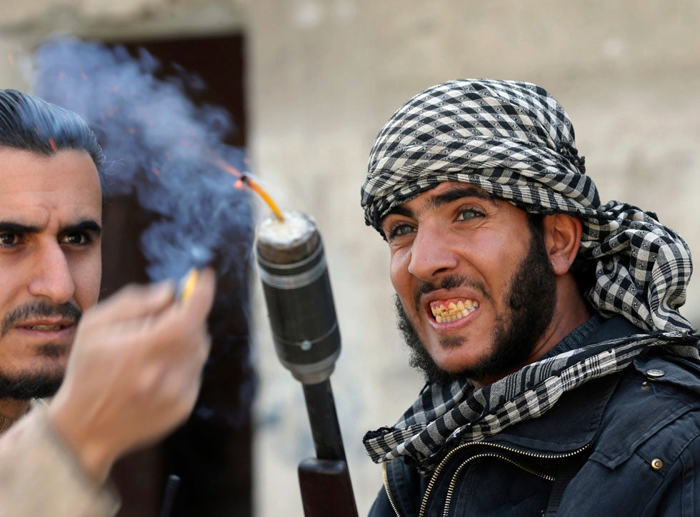 Fighters from the Free Syrian Army's Tahrir al Sham brigade use a shotgun to fire an improvised grenade at Syrian Army soldiers in the Arabeen neighborhood of Damascus. Goran Tomasevic is a Reuters staffer who predominantly covers wars and conflicts. We've recently made a point of including at least one of his images from the frontlines, in our weekly round-ups. Check out some of our favorites <a href="http://www.americanphotomag.com/photo-gallery/2013/02/photojournalism-week-february-1-2013?page=1">here</a> and <a href="http://www.americanphotomag.com/photo-gallery/2012/11/photojournalism-week-november-9-2012?page=6">here</a>.