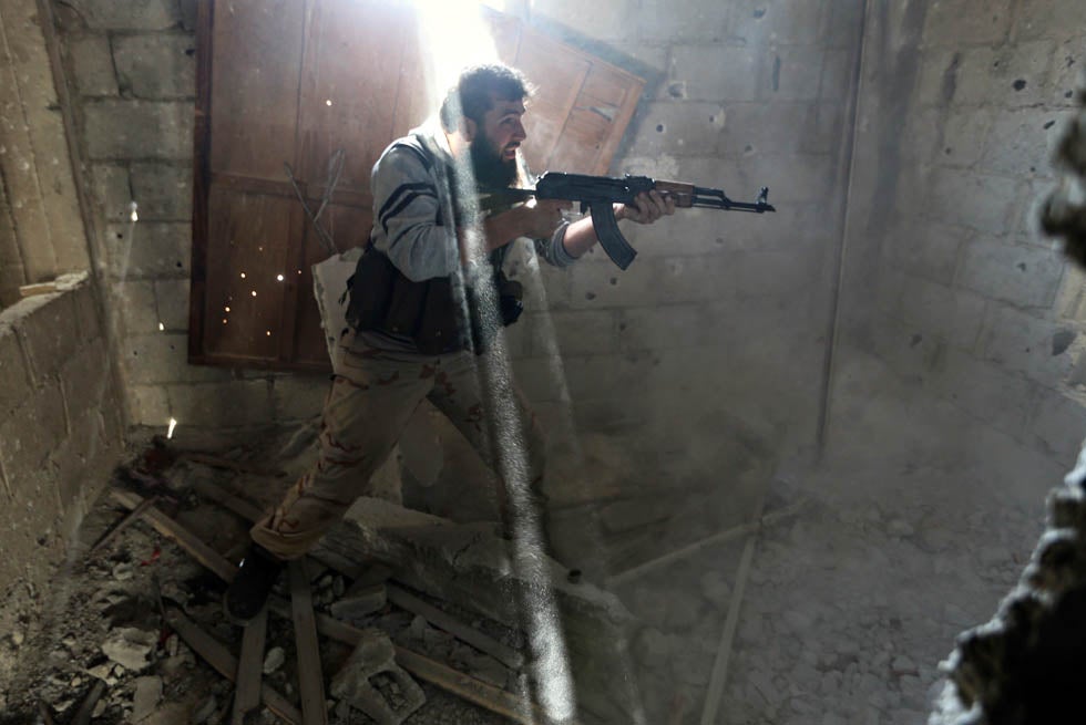 A fighter from the Free Syrian Army's Tahrir al Sham brigade fires back at the Syrian army during heavy fighting in Mleha suburb of Damascus. Goran Tomasevic is a Reuters staffer who predominantly covers wars and conflicts. He has previously photographed in Libya, Syria, Egypt and Iraq. In 2003 and 2005 he was named Reuters' Photographer of the Year. See more of his work <a href="http://www.americanphotomag.com/photo-gallery/2012/11/photojournalism-week-november-9-2012?page=6">here</a>.