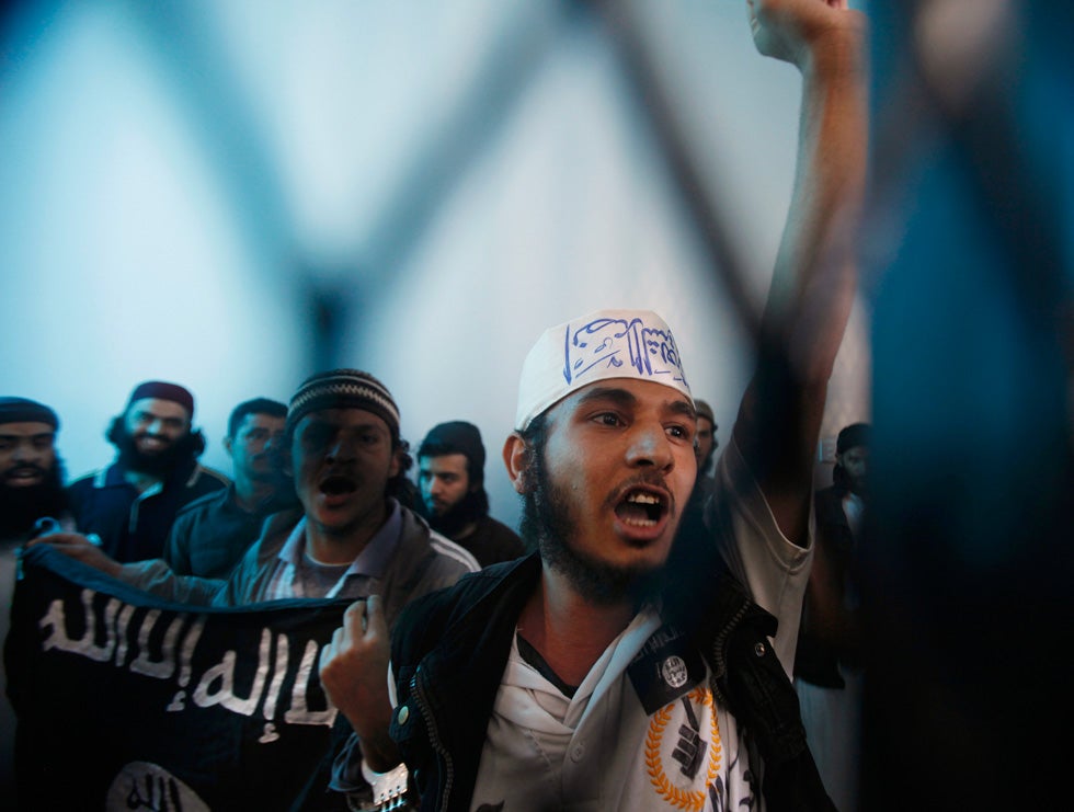 Defendants linked to al Qaeda react as a verdict upholding their jail sentences are announced at a state security court of appeals, in Sanaa, Yemen. Khaled Abdullah is a Reuters staff photographer based in Yemen. Check out more of his work <a href="http://www.americanphotomag.com/photo-gallery/2013/03/photojournalism-week-march-29-2013?page=4">here</a>.