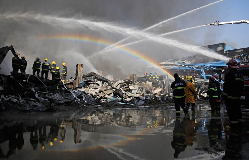 Firefighters try to extinguish a fire at the Hangzhou Yusei Machinery Co.,Ltd in Xiaoshan District in Hangzhou, Zhejiang Province, China.