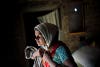 Kala Lakavath a "cotton widow" in Andhra Pradesh, India, prepares for a long day in the fields to pay off her family's debts. Her husband committed suicide by drinking pesticide three years ago. Andhra Pradesh, India. November 15, 2013. <em>Andrea Bruce is a documentary photographer who brings attention to people living in the aftermath of war. In 2012 she was the first photojournalist to be awarded the Chris Hondros Fund Award. See more of her work <a href="http://www.andreabruce.com/">here. </a></em>