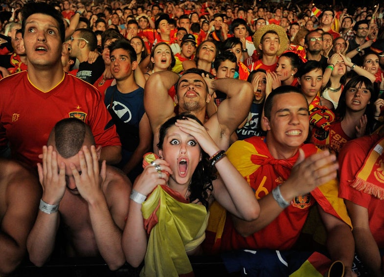 MADRID, SPAIN - JUNE 27: Spanish fans react while watching on a giant outdoor screen on Paseo de La Castellana street the UEFA EURO 2012 semi-final match between Spain and Portugal on June 27, 2012 in Madrid, Spain. (Photo by Denis Doyle/Getty Images)
