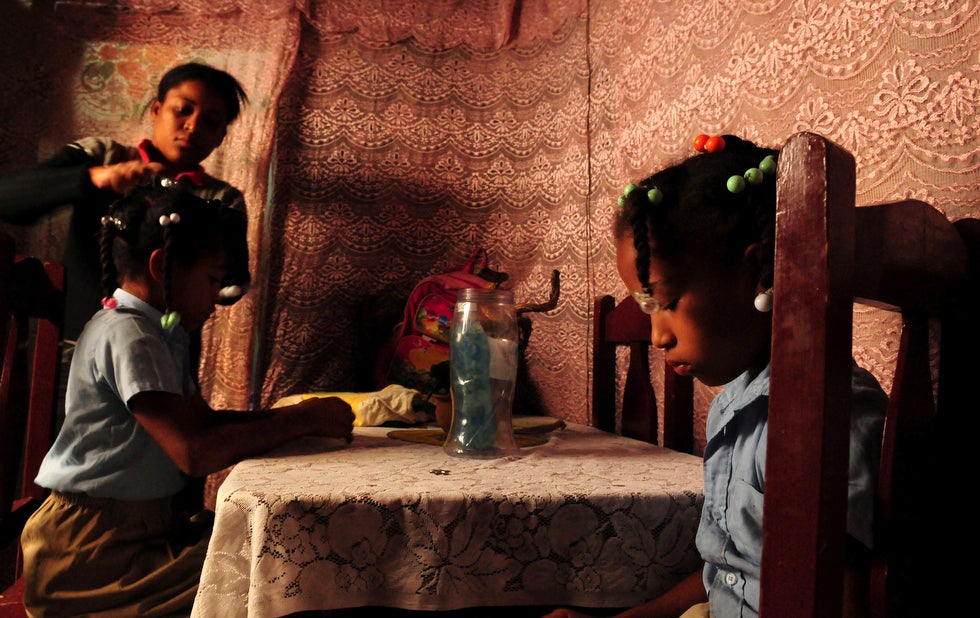 Taken on the occasion of International Women’s Day, Ricardo Rojas photographed Evelyn de los Santos, a single mother living in one of Santo Domingo’s largest slums, combing her daughter’s hair before heading school. Rojas is a Reuters stringer based in and around Santo Domingo.