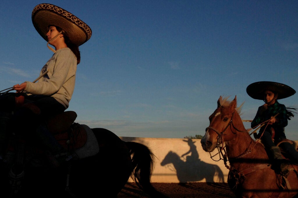 Caterina Ozuna and Miriam Alejandra Montecillos warm up before practicing their routine for Pre-Estatal at El Rancho Unico in Atascosa, Texas, U.S. on March 26, 2015.  "You feel the nerves the moment you go in," Ozuna said.
