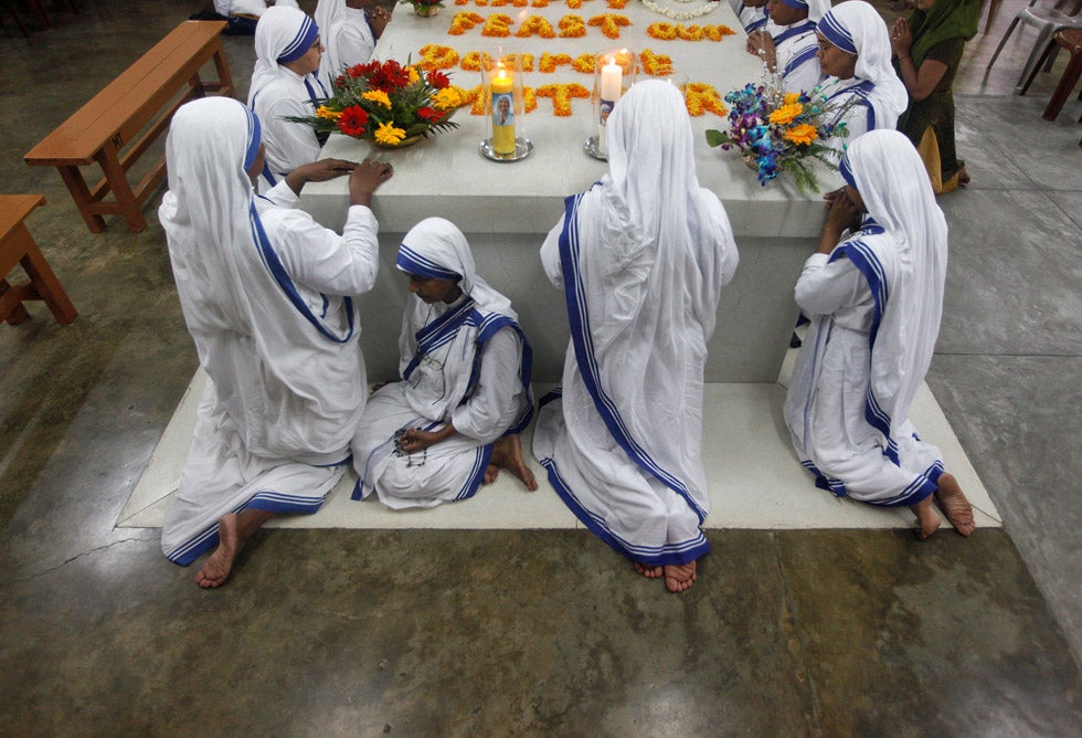 Catholic nuns from the Missionaries of Charity, the global order of nuns founded by Mother Teresa, pray at Teresa's tomb on her 15th anniversary of her death in Kolkata. Rupak De Chowdhuri is an India-based Reuters photographer.