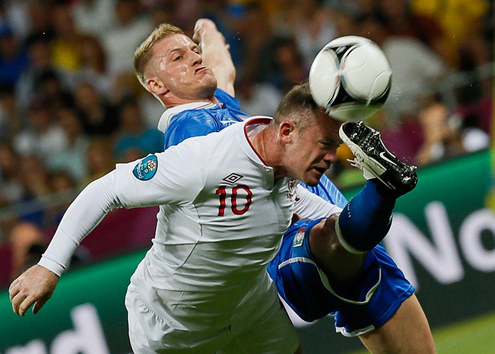 Italy's Ignazio Abate (L) challenges England's Wayne Rooney during their Euro 2012 quarterfinal soccer match at the Olympic stadium in Kiev, Ukraine. Tony Gentile is a Reuters staffer based in and around Europe. He recently posted a very interesting read (with photos) on his Reuters blog. Check it out <a href="http://blogs.reuters.com/photographers-blog/2012/06/16/soccer-and-history/">here</a>.