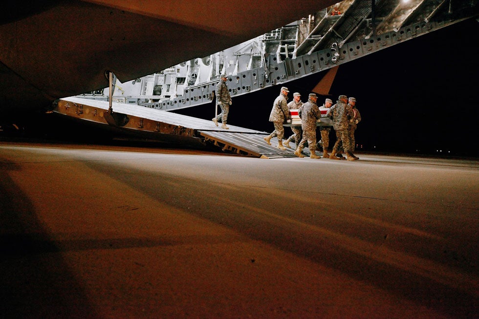 <a href="http://www.eddieadamsworkshop.com/usr/usr-show?U_ID=U0000nmAUv3jEv0c">Chip Somodevilla</a>, a Getty staff photographer ,captured this intimate moment of U.S. Army soldiers carrying the body of Brig. Gen. Terence J. Hildner during what is known as a dignified transfer at Dover Air Force Base, in Delaware. Hildner, a one-star general, was found dead in his sleeping quarters while stationed in Kabul. He is the highest-ranking officer to die in the war in Afghanistan, according to the State Department. Chip Somodevilla lives and works in Washington D.C. covering political assignments primarily. Prior to joining Getty in 2006, he was a photographer at the Fort Wayne News-Sentinel, the Fort Worth-Telegram and the Detroit Free Press.