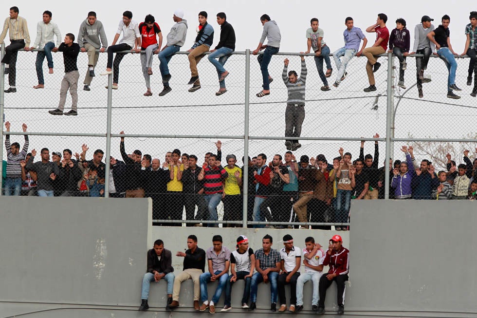 Soccer fans watch Jordan play Japan during a 2014 World Cup qualifying match at King Abdullah stadium in Amman, Jordan. Muhammad Hamed is a photojournalist working for Reuters in Jordan.