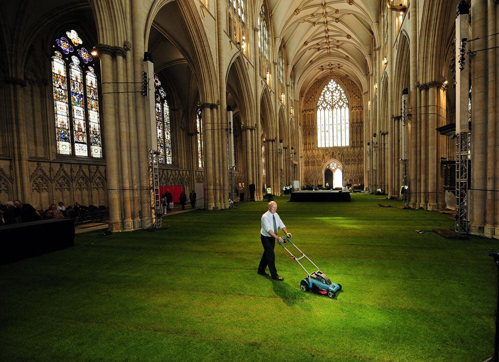 1500 square feet of grass, laid out in York Minster for the Queen’s Diamond Jubilee celebration dinner, is carefully manicured before guests arrive. John Giles is a Press Association Wire staff photographer based in England.