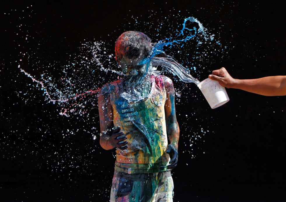 A boy smeared with colours reacts as another boy pours water on him during Holi celebrations in the southern Indian city of Chennai. Holi, also known as the Festival of Colours, heralds the beginning of spring and is celebrated all over India. Babu Babu is a Reuters phographer based in Chennai. See more of his work <a href="http://www.americanphotomag.com/photo-gallery/2013/02/photojournalism-week-february-1-2013?page=8">here</a>.